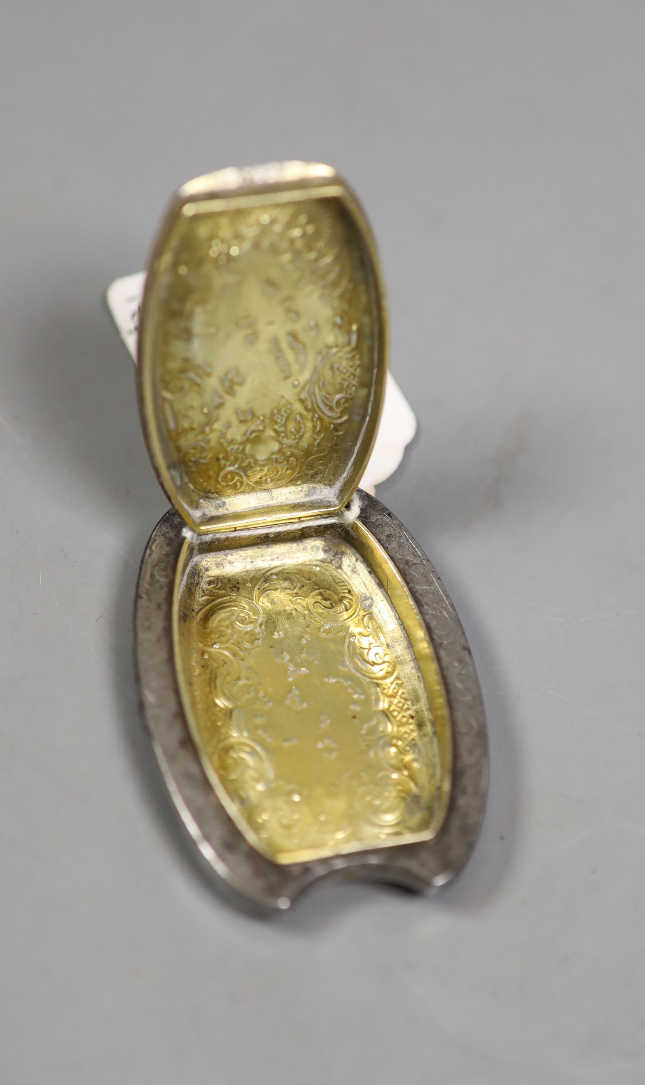 A 19th century French gilt white metal and steel shaped oval tinder box, with stag's head and foliate decoration, 52mm.